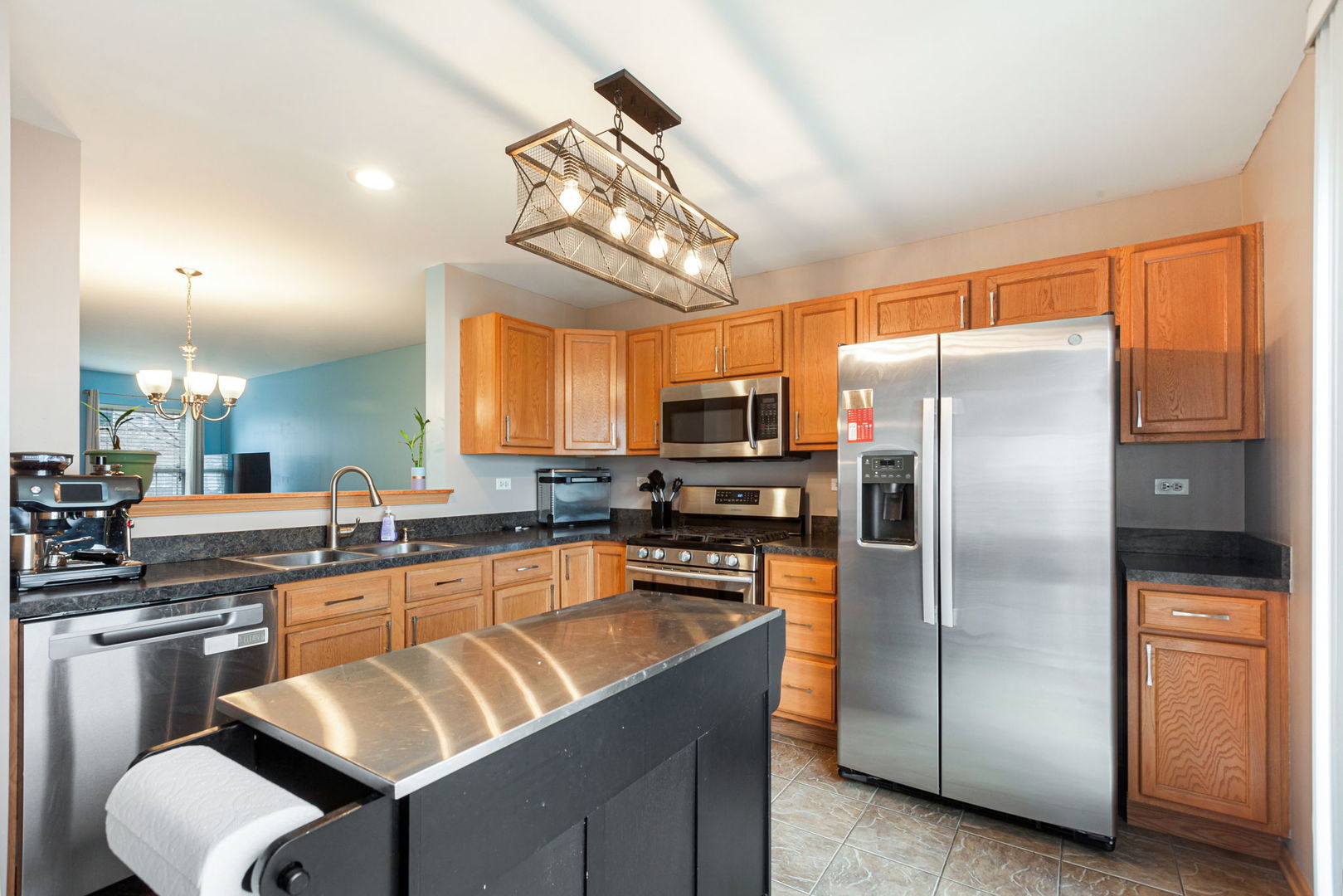 932 Clover Lane Pingree Grove, IL 60140 - Photo 5 of 19 a kitchen with stainless steel appliances granite countertop a refrigerator a sink a stove a dining table and chairs