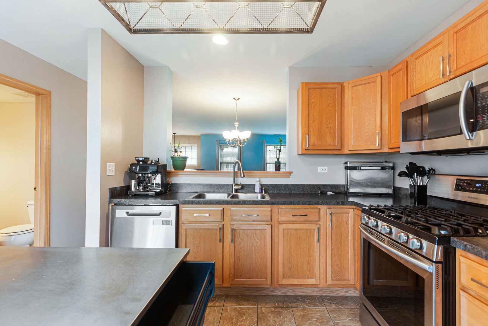 932 Clover Lane Pingree Grove, IL 60140 - Photo 6 of 19 a kitchen with stainless steel appliances granite countertop a stove a sink and a microwave