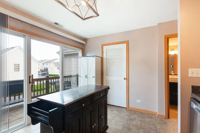 a view of a kitchen with granite countertop a sink and a refrigerator
