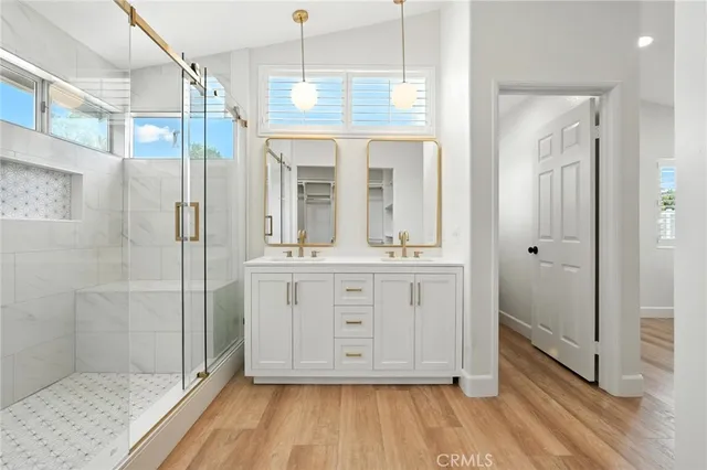 a bathroom with a double vanity sink and shower