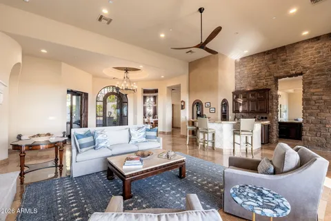 a living room with fireplace furniture and a table