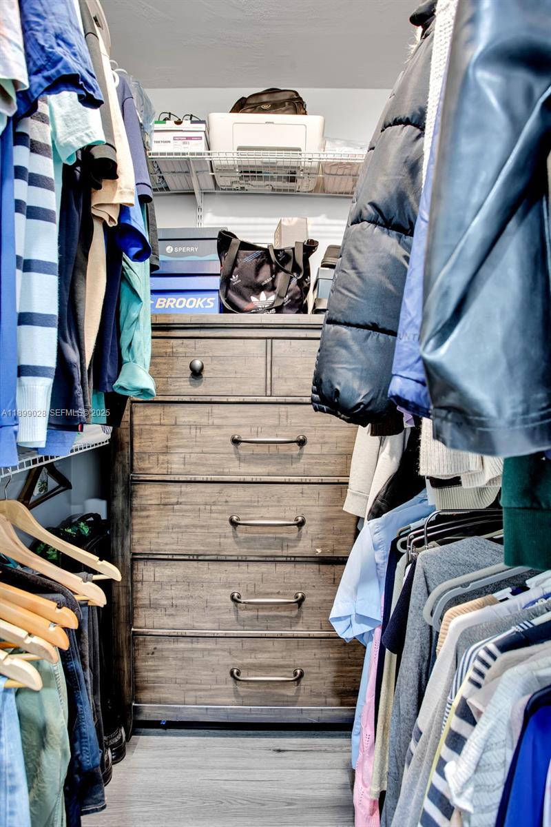 16922 Southwest 107th Place Miami, FL 33157 - Photo 29 of 45 a view of walk in closet with clothes and shoes