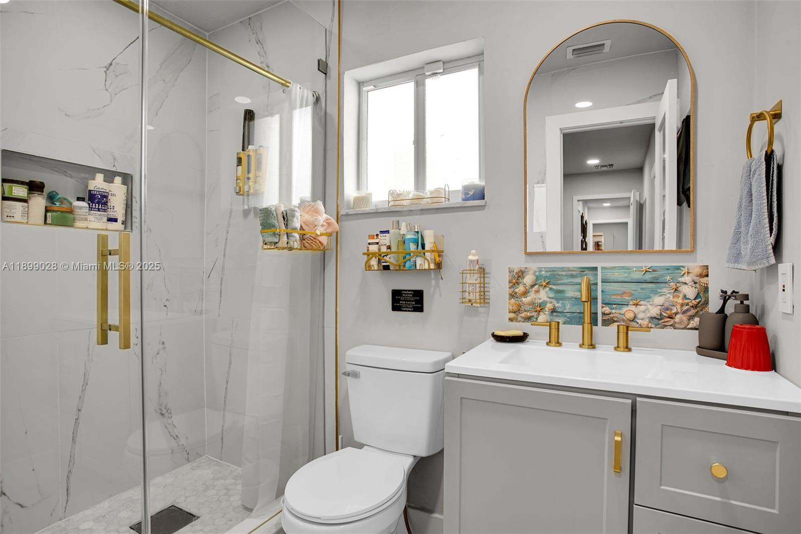 16922 Southwest 107th Place Miami, FL 33157 - Photo 30 of 45 a bathroom with a sink a toilet and shower