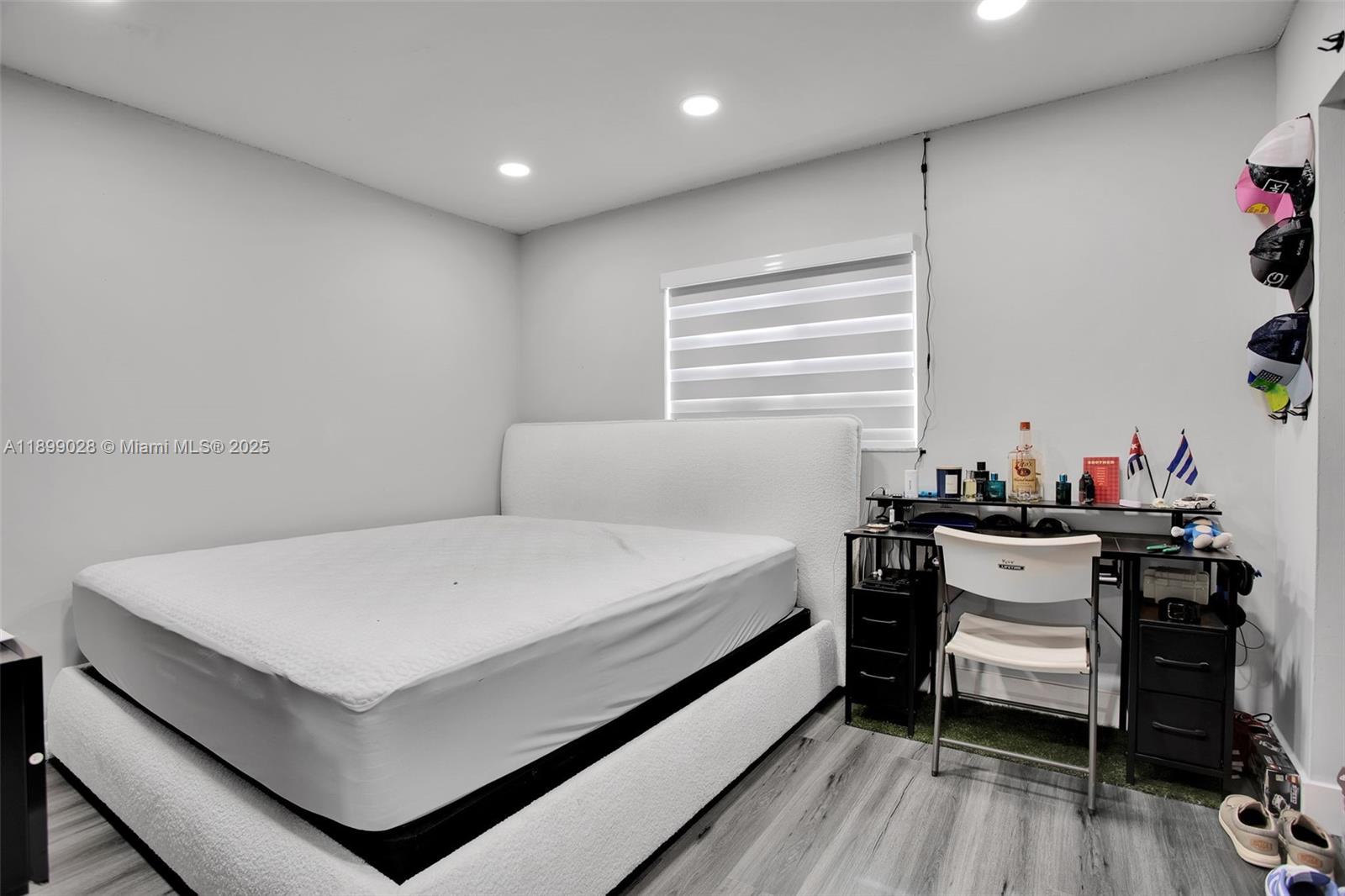 16922 Southwest 107th Place Miami, FL 33157 - Photo 31 of 45 a bedroom with a bed and a table