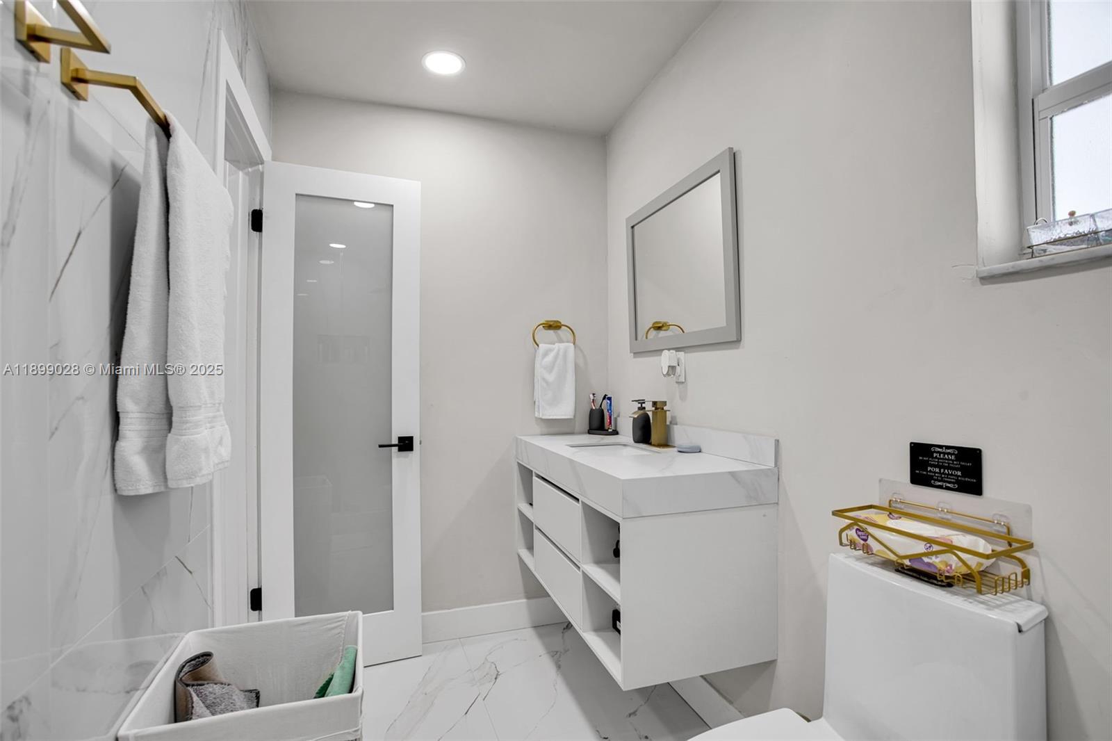 16922 Southwest 107th Place Miami, FL 33157 - Photo 33 of 45 a bathroom with a sink and a mirror