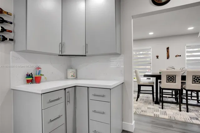 a living room with furniture a window and a dining table