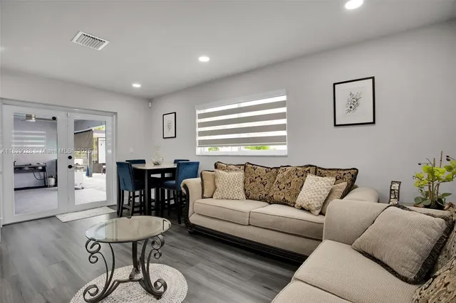 a living room with furniture a wooden floor and a fireplace