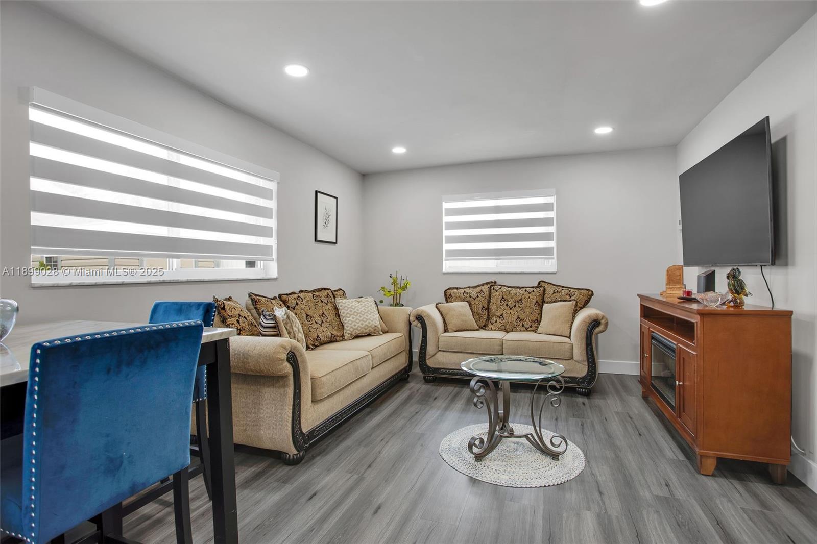 16922 Southwest 107th Place Miami, FL 33157 - Photo 43 of 45 a living room with furniture and a flat screen tv