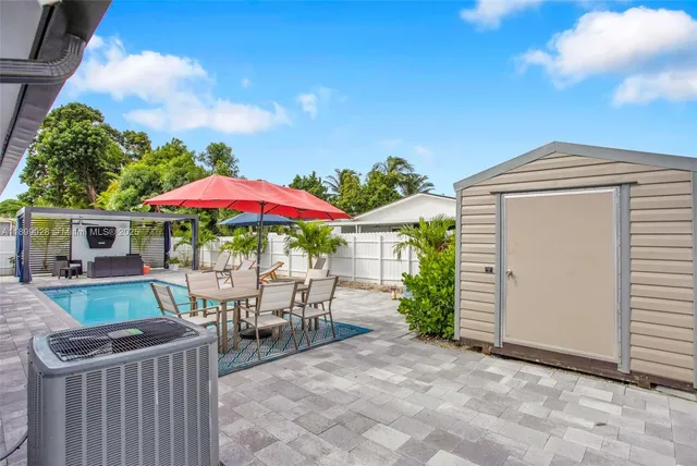 a view of a house with backyard and sitting area