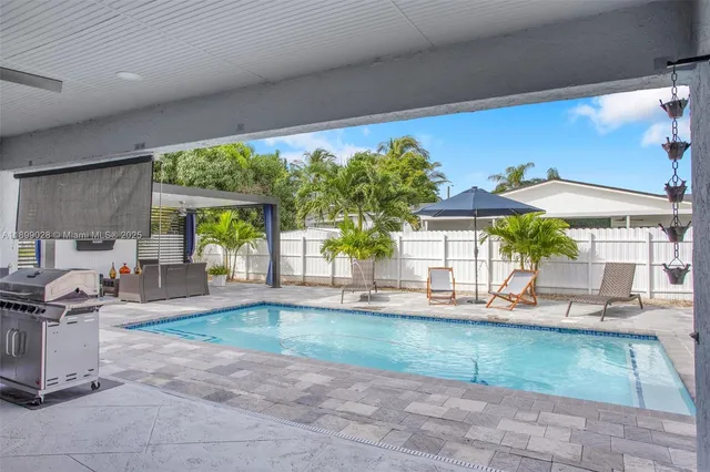 a view of a house with backyard sitting area and garden