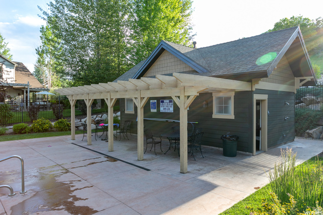 557 Craftsman Way Midway, UT 84049 - Photo 59 of 59 Recreational building featuring a pergola-covered patio, dark green siding, light-toned trim, and a shingled roof
