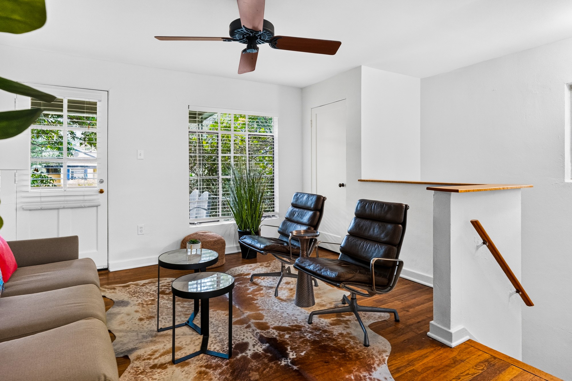 1302 Kirkwood Road, Unit B Austin, TX 78722 - Photo 3 of 21 Well-lit living area features a convenient ceiling fan and warm hardwood flooring.