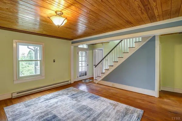 a view of an entryway with wooden floor and door