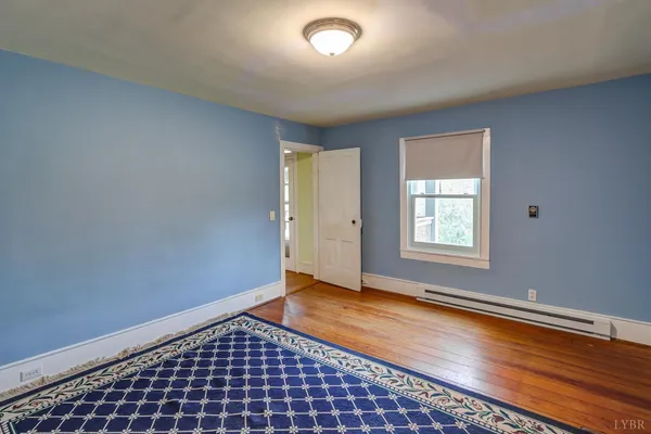 a blue couch sitting in a room next to a window
