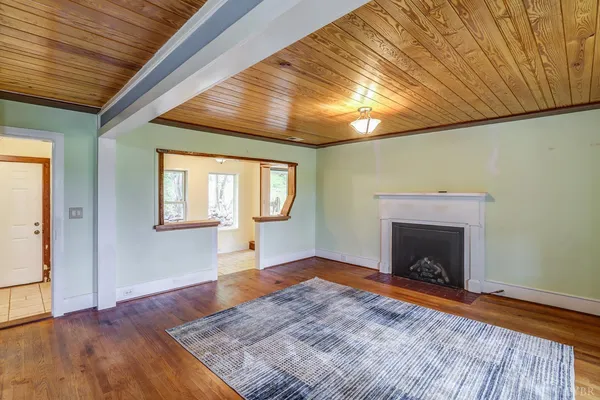 a view of hallway with furniture and a floor to ceiling window