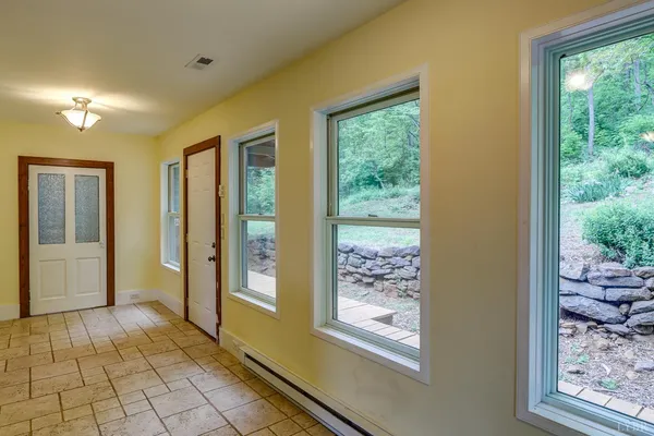 a view of a room with a ceiling fan and a floor to ceiling window