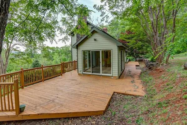 an aerial view of a house with a yard and large trees