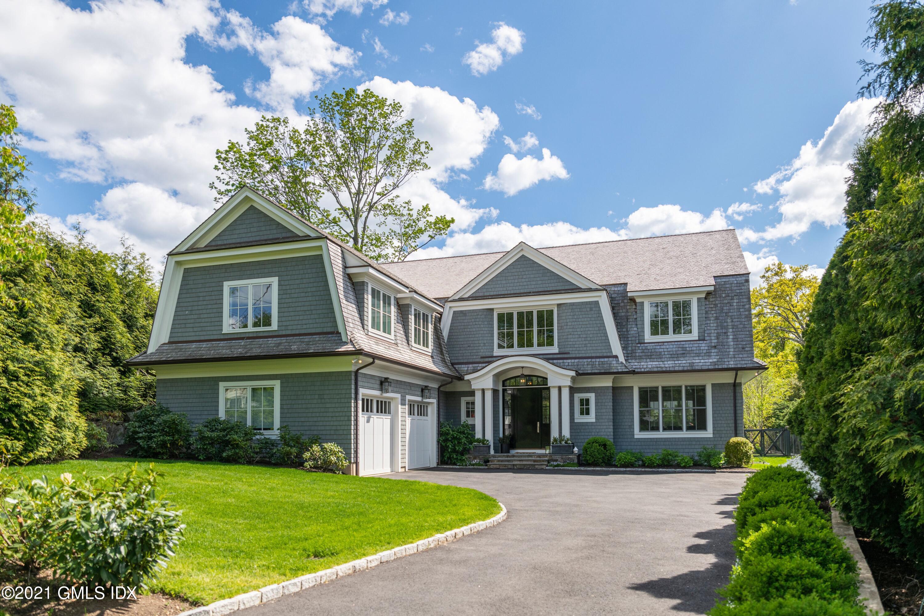 a front view of a brick house with a yard