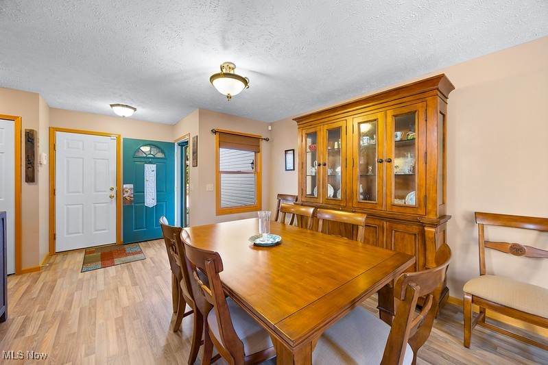 1035 Parsons Road Grafton, OH 44044 - Photo 6 of 25 Dining space with light wood-type flooring and a textured ceiling
