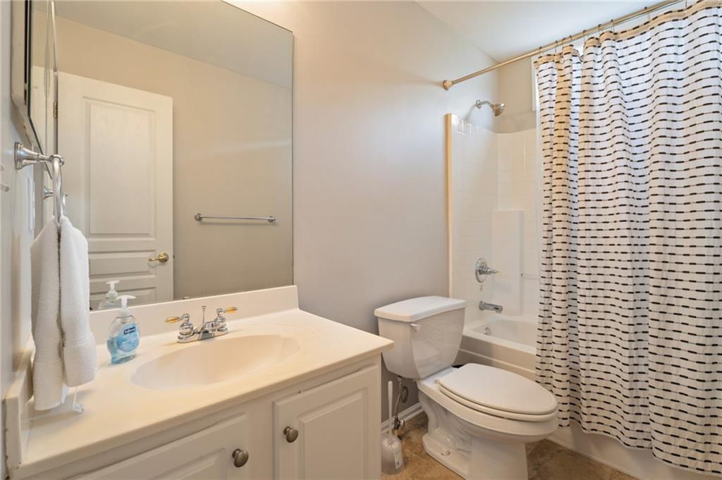 878 Scales Road Suwanee, GA 30024 - Photo 15 of 17 a bathroom with a sink a toilet and shower