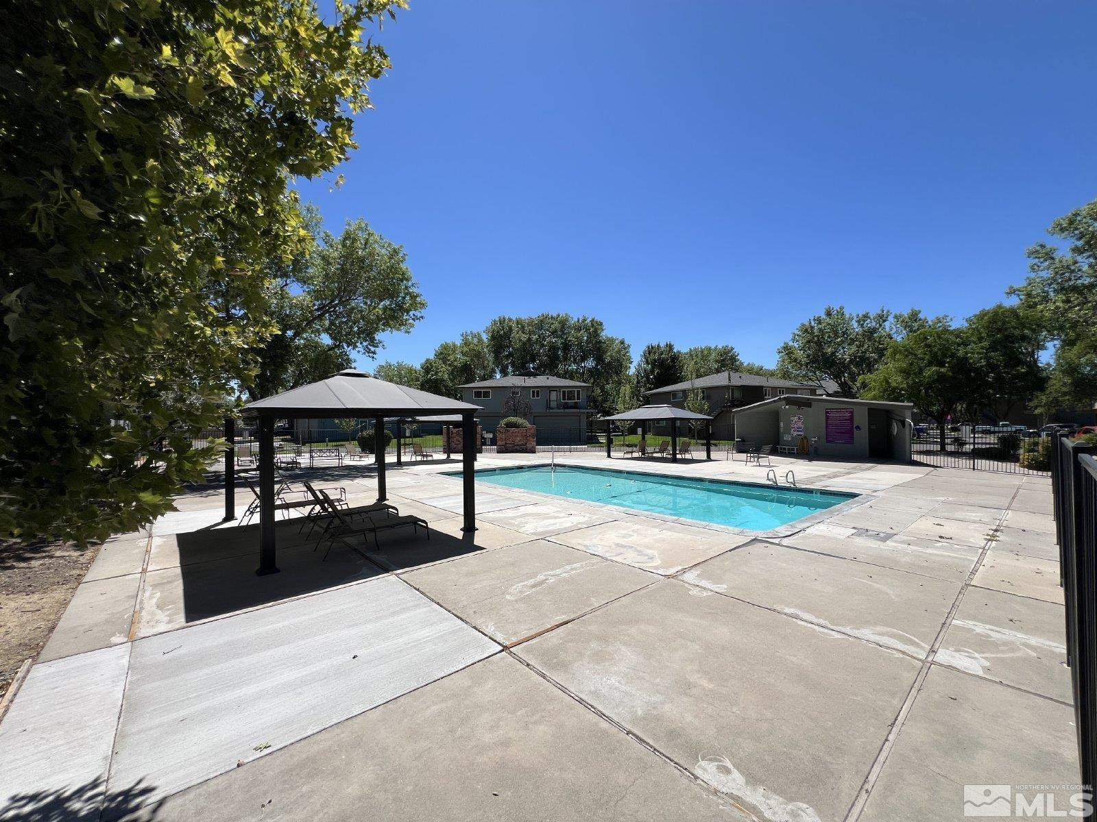 613 Pine Meadows Drive, Unit 4 Sparks, NV 89431 - Photo 13 of 14 a view of a terrace with chairs and potted plants