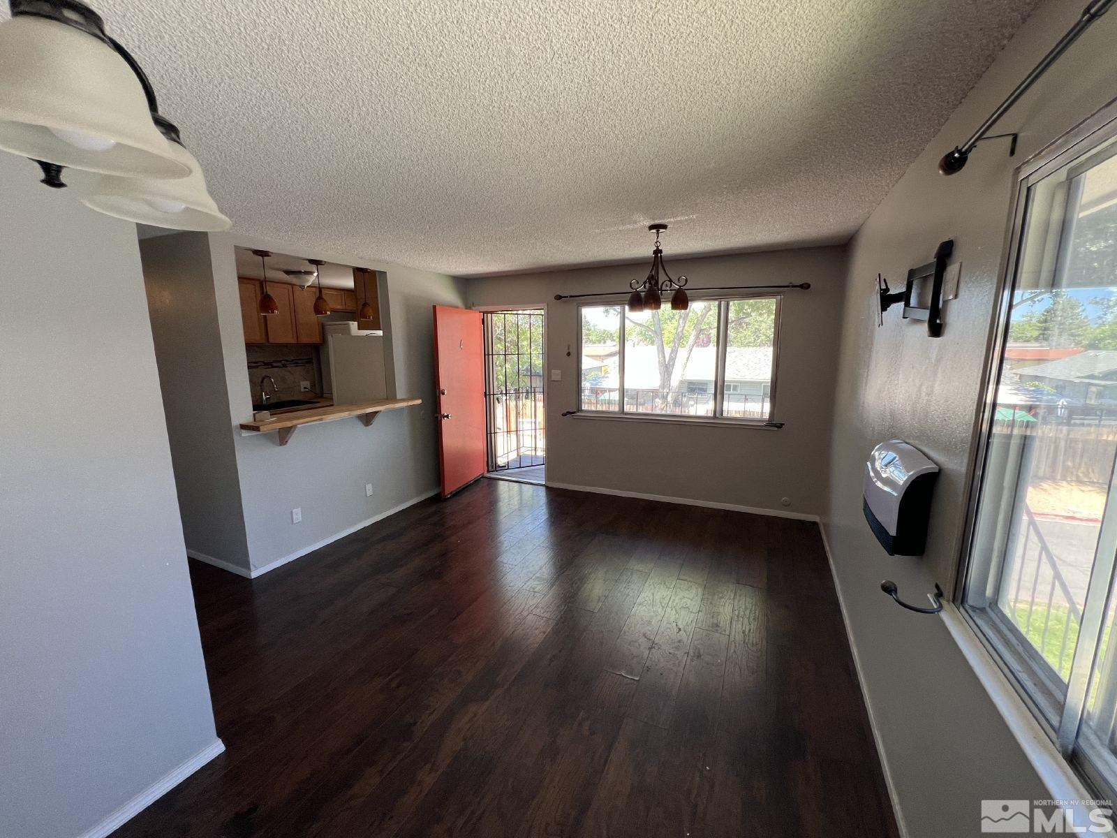 613 Pine Meadows Drive, Unit 4 Sparks, NV 89431 - Photo 3 of 14 wooden floor in an empty room with a window