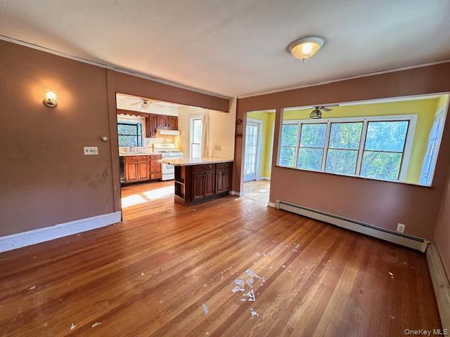 55 Woodhull Landing Road Sound Beach, NY 11789 - Photo 14 of 38 an empty room with wooden floor and windows