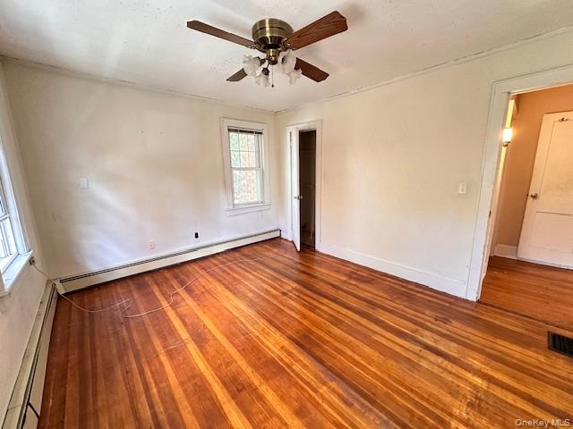 55 Woodhull Landing Road Sound Beach, NY 11789 - Photo 16 of 38 a view of empty room with wooden floor and fan
