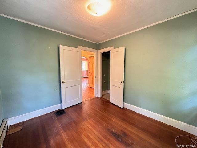 55 Woodhull Landing Road Sound Beach, NY 11789 - Photo 21 of 38 an empty room with wooden floor and windows