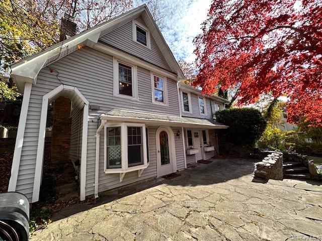 55 Woodhull Landing Road Sound Beach, NY 11789 - Photo 3 of 38 a view of a house with a yard covered in snow