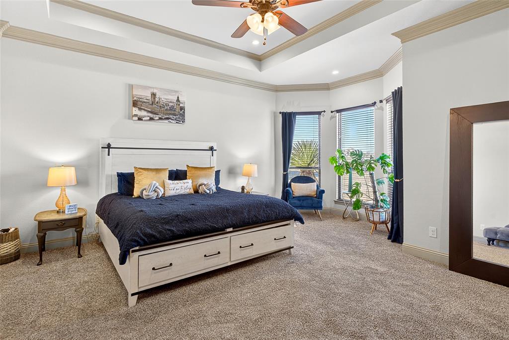 12099 Briargrove Lane Forney, TX 75126 - Photo 12 of 38 Carpeted bedroom with a raised ceiling, ornamental molding, and ceiling fan