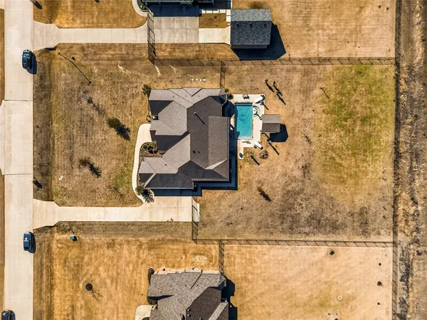a living room with patio furniture and a floor to ceiling window