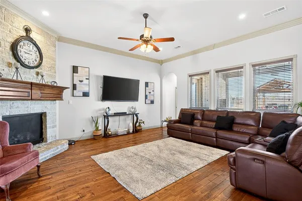 a living room with furniture a fireplace and a flat screen tv