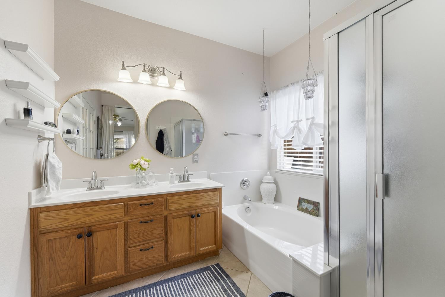 2220 Ellison Drive Modesto, CA 95355 - Photo 26 of 53 a spacious bathroom with a double vanity sink mirror and bathtub