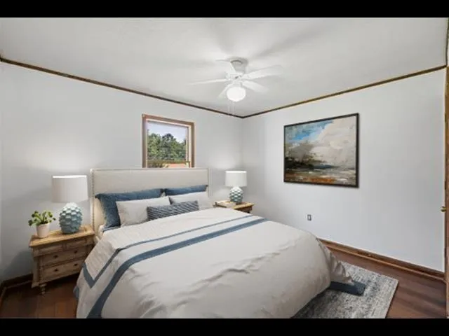 a view of a room with a ceiling fan and window