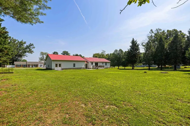 a view of a house with a yard and sitting area