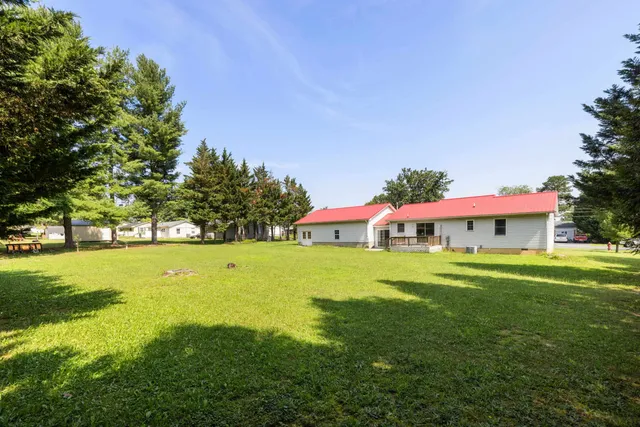 an aerial view of residential houses with outdoor space and swimming pool