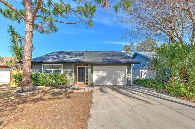 a front view of a house with yard and trees