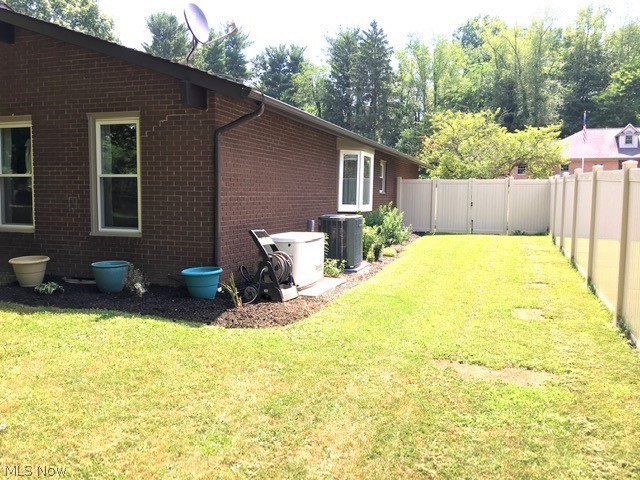 1951 Devonshire Road Northwest Canton, OH 44708 - Photo 9 of 35 East side view from back yard, All new windows in 2020 including bay. Whole house Generac generator and Trane AC (2019).