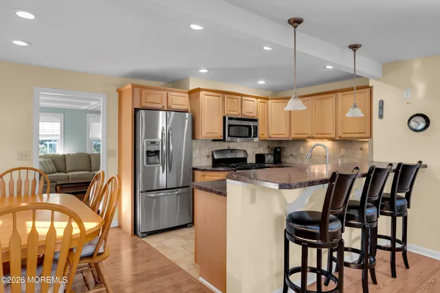 a kitchen with kitchen island a large counter top space appliances and cabinets