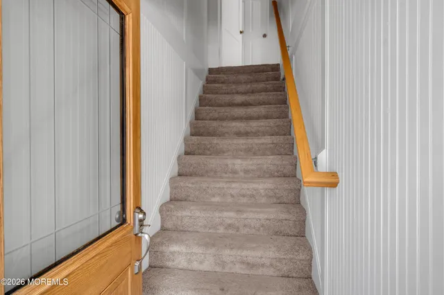 a view of staircase with white walls