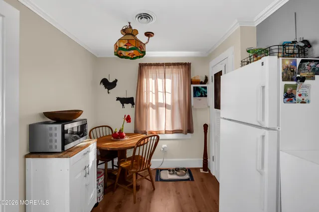 a dining room with furniture and a chandelier