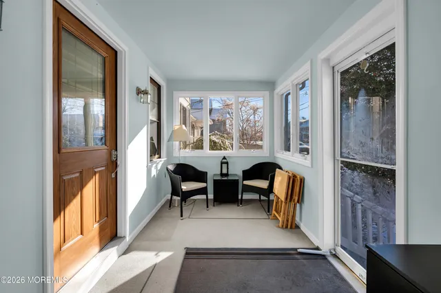a view of a livingroom with furniture wooden floor and windows