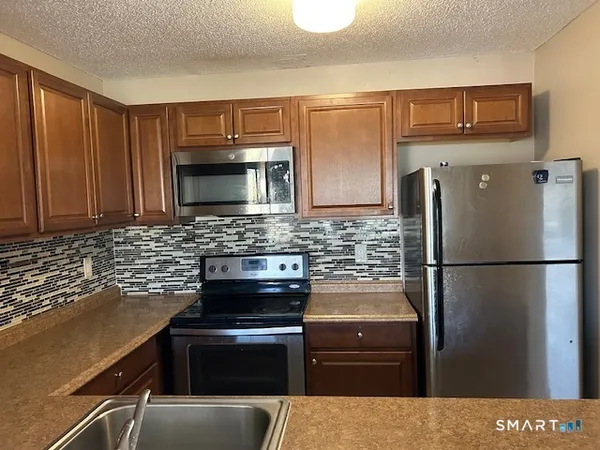 a kitchen with a refrigerator stove and microwave