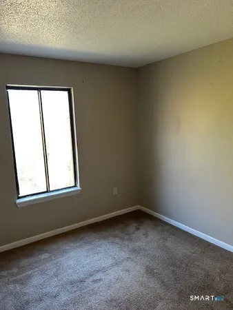 a view of an empty room and entryway