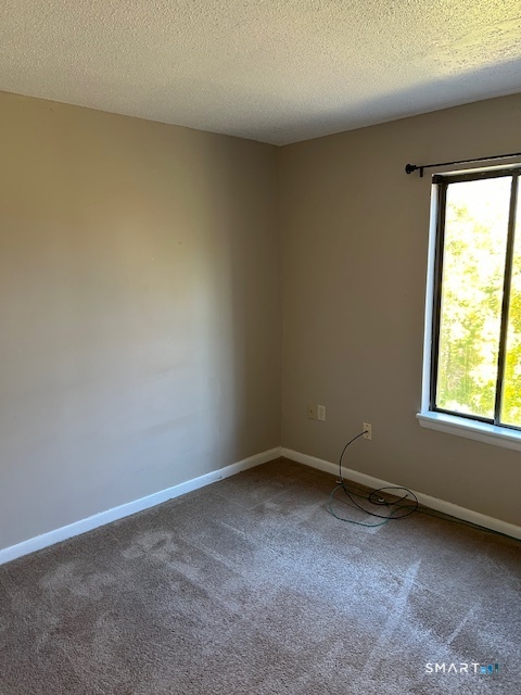 175 Mill Pond Road, Unit 214 Hamden, CT 06514 - Photo 13 of 22 an empty room with a window