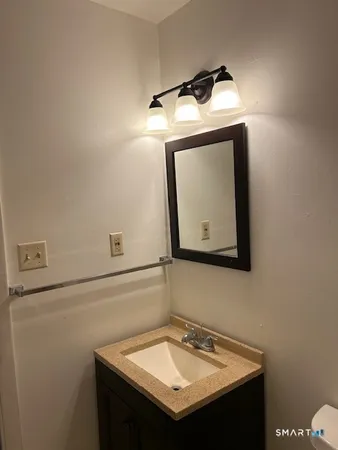a white toilet sitting next to a bathroom sink