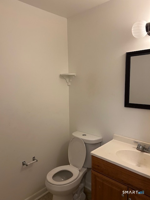 175 Mill Pond Road, Unit 214 Hamden, CT 06514 - Photo 18 of 22 a white toilet sitting next to a bathroom sink