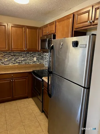 a white refrigerator freezer sitting inside of a kitchen