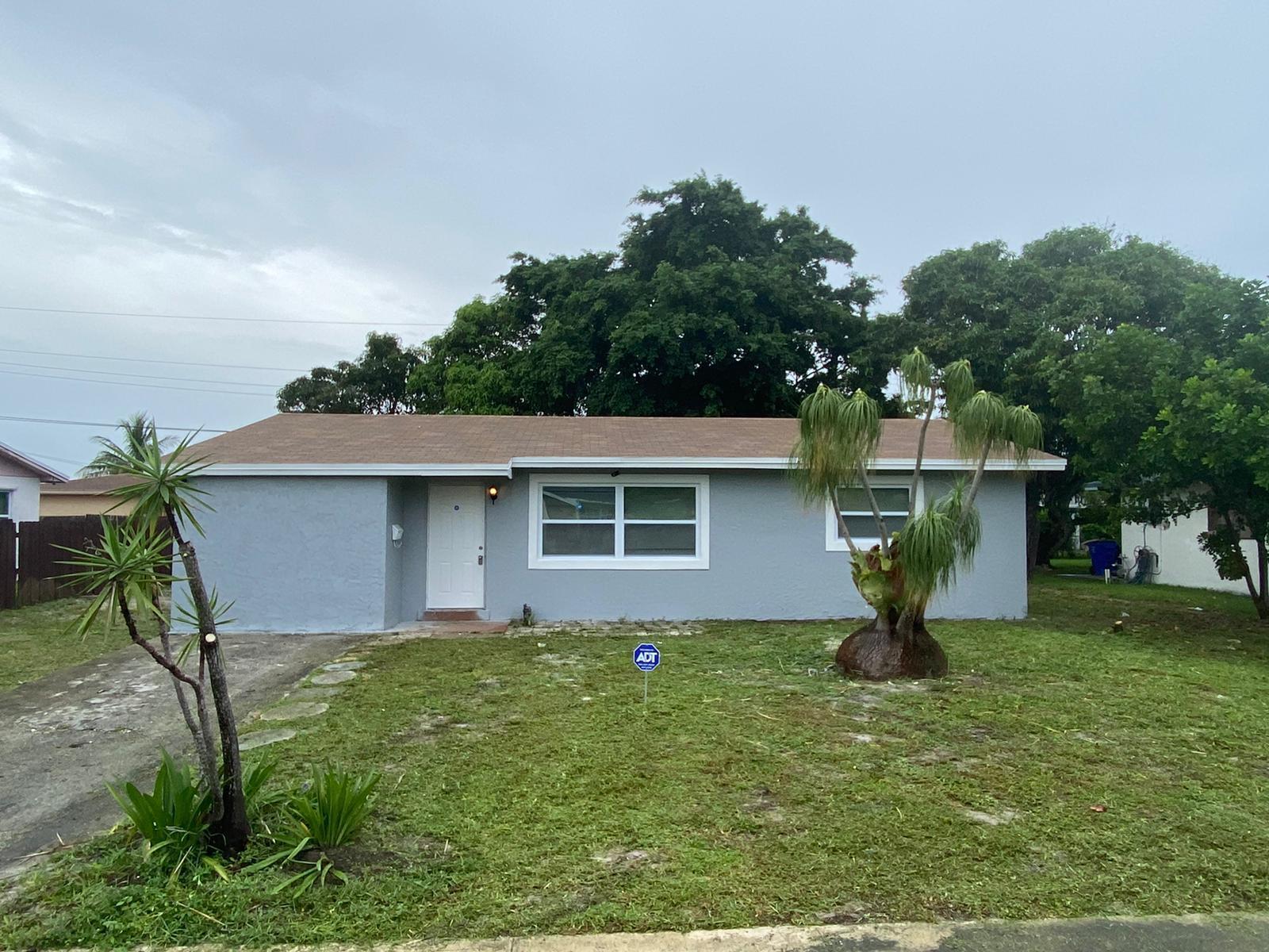811 Southwest 12th Court Deerfield Beach, FL 33441 - Photo 12 of 16 a front view of a house with garden